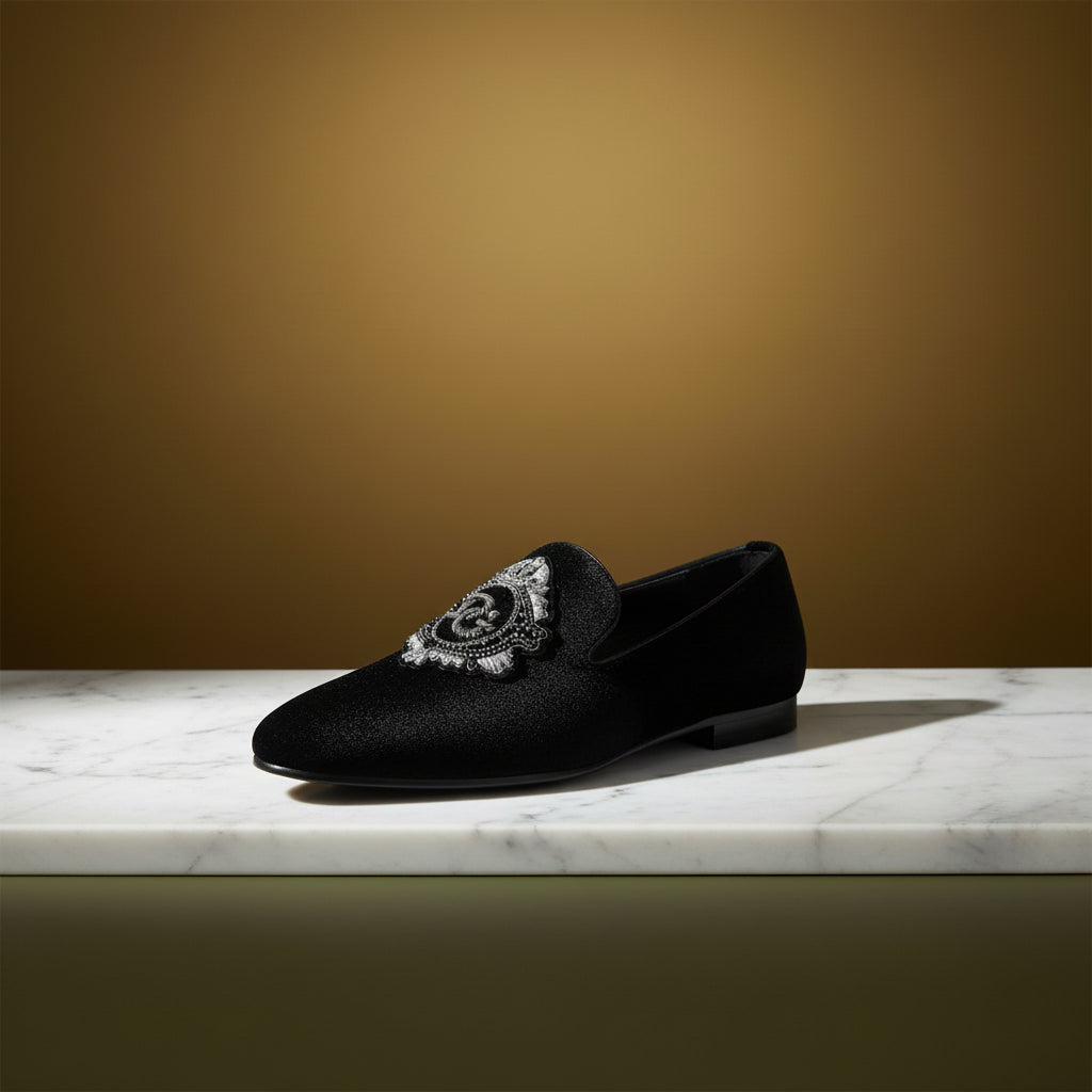 Black loafer with decorative emblem 