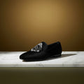 Black loafer with decorative emblem 