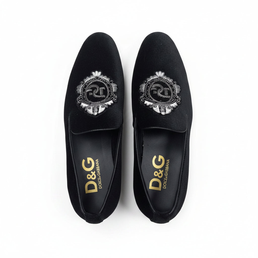 Black loafers with decorative emblems 