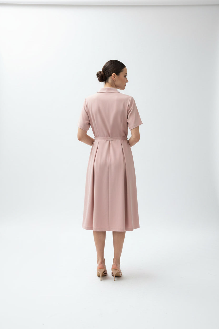 Pink robe with a belt hanging on a hook against a neutral background