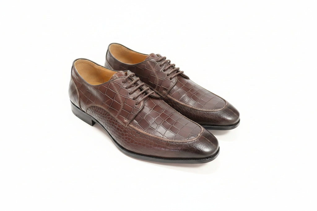 Brown dress shoes on a white surface