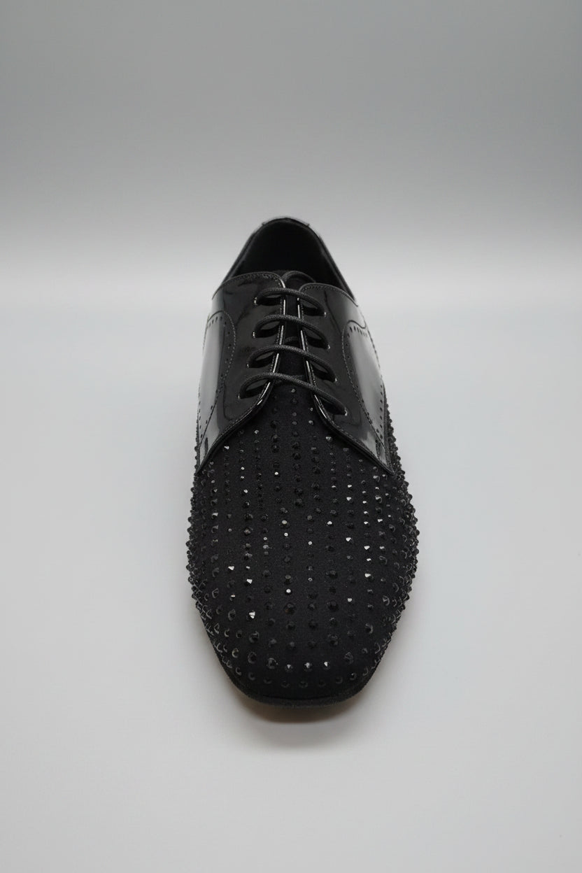 Black dress shoe with rhinestone embellishments on a white surface